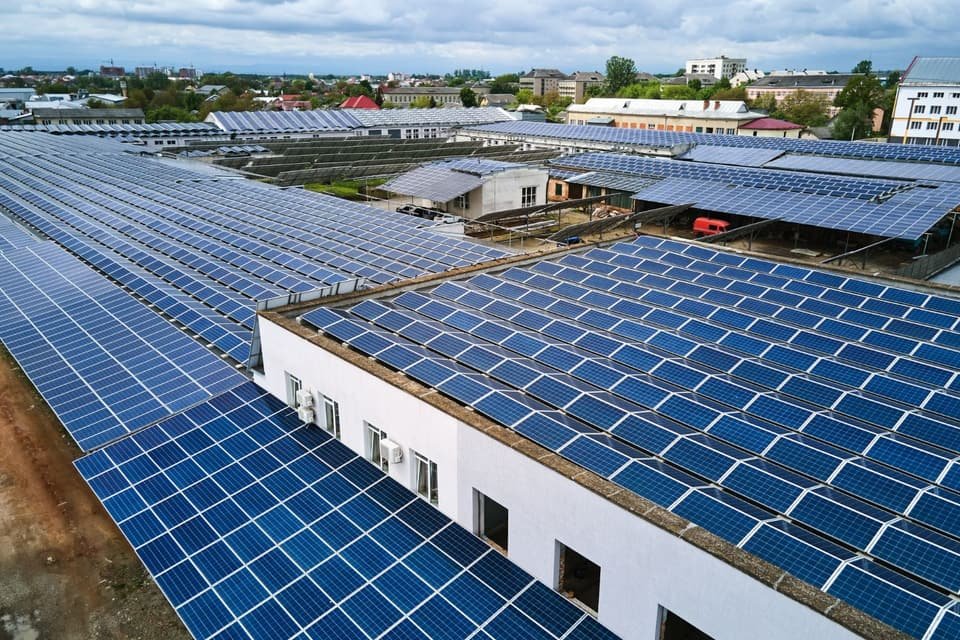 Solar panels covering large commercial roofs